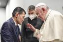 Pope Francis speaks to Abdullah Kurdi, left, father of Alan Kurdi, a 3-year old Syrian boy who's image made headlines after he drowned in the Mediterranean Sea and drew global attention to Europe's refugee crisis. (Vatican Media via AP)