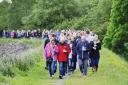 REMEMBRANCE: Scores of people pay their tributes to James during a candlelit walk around Foulridge Reservoir