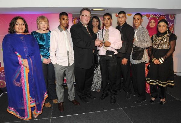 Canon Chris Chivers from Blackburn Cathedral and members of the Woman's Voice team present the Youth Leadership Award to ‘Don’t Hate Us Rate Us’ of Rochdale.
