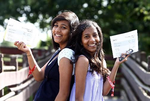Chelmsford High School for Girls pupils Tharshi Singam, (left) who got an
A*, two A grades and a B, and Priya who got two A* grades, an A and a B,
celebrate receiving their A-level results.