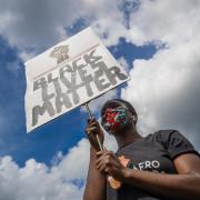 A woman holding a banner during in a Black Lives Matter protest rally at Woodhouse Moor in Leeds in June 2020 (Lawson/PA)