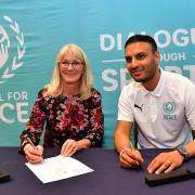 Kash Siddiqi co founder of Football for Peace (right) and Shirley Congdon (left), vice chancellor of Bradford University, sign the agreement to launch the football for Peace project. Pic: Mike Simmonds