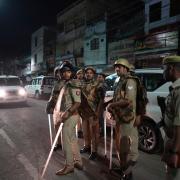Policemen stand guard in the area where Atiq Ahmad and his brother Ashraf were shot in, Prayagraj, India (Rajesh Kumar Singh/AP)