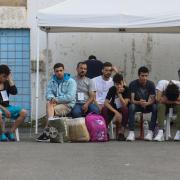 Survivors wait to board a bus to transfer to Athens at the port of Kalamata (John Liakos/InTime News/AP)