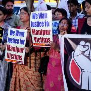 People protest against ethnic violence and mob assaults in Manipur (Bikas Das/AP)