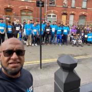 Afruz Miah with walkers who raised £20,000 for a family affected by a house fire in Oldham