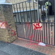Aftermath: gates at the mosque are daubed in red after the latest incident