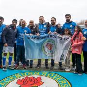 Group ambassadors Tez and Dilan Markanday with members of the South Asian Supporters (SAS) at Ewood Park