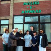 Nurses, therapists and members of the Chaplaincy service at East Lancashire Hospitals gratefully receive a £3,400 donation from Masjid-e-Anwaar members.