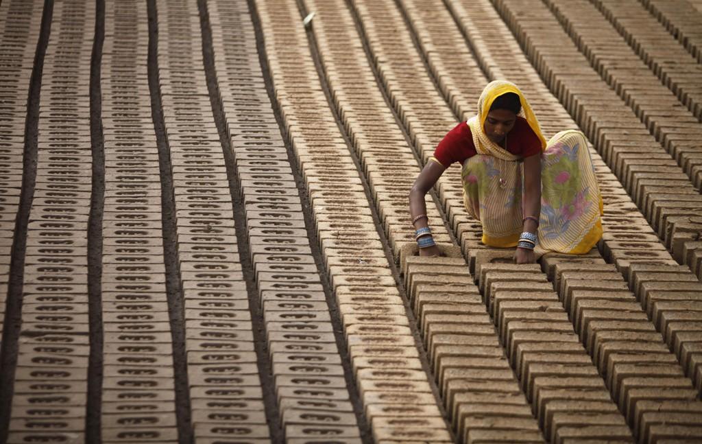 An Indian woman works at a brick factory on the outskirts of Jammu, India.