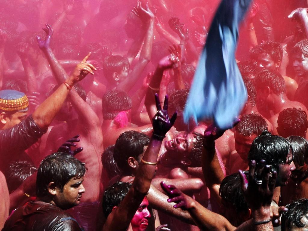 Indians throw colored powder and dance as they celebrate "Holi," the festival of colors, in Allahabad, India, Friday, March 9, 2012. Holi, the Hindu festival of colors, also heralds the coming of spring. (AP Photo/Rajesh Kumar Singh) 
