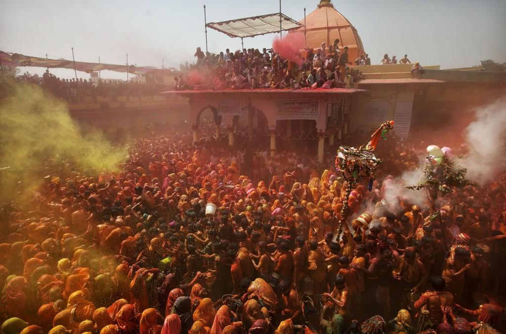 Coloured powder and water is thrown as Indian Hindu devotees take part in "Huranga" during Holi celebrations, the Hindu festival of colors at the Baldev Temple in Dauji, 180 kilometers (113 miles) south of New Delhi, India, Friday, March 9, 2012. 