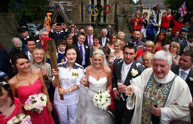 The Wedding of Catherine Lloyd (centre) and Darren Heys in Rawtenstall on the Torch Relay leg between Burnley and Rawtenstall.