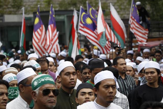 Muslims march towards the U.S. Embassy during a protest against the anti-Islam film "Innocence of Muslims" and the publication of caricatures of the Prophet Muhammad by a French satirical weekly outside a mosque in Kuala Lumpur