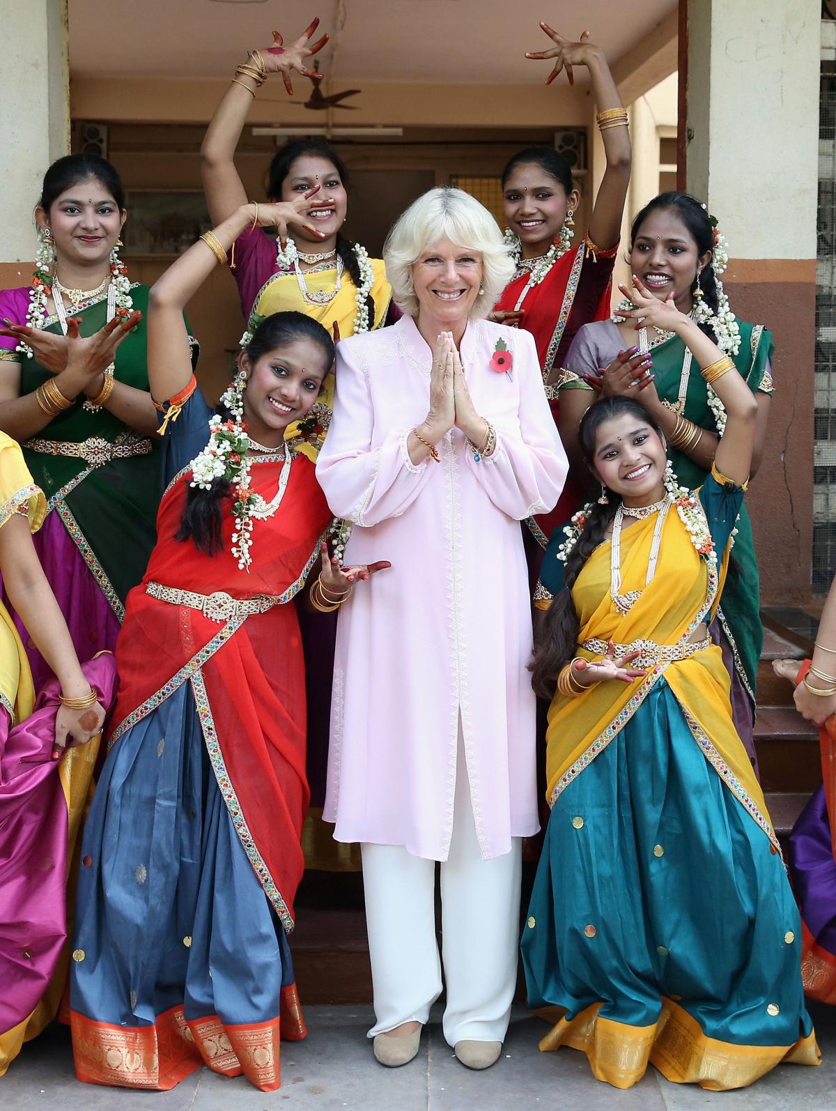 The Duchess of Cornwall is shown some Indian dance moves by girls from Asha Sadan (House of Hope) for children who have been abandoned or abused, in Mumbai