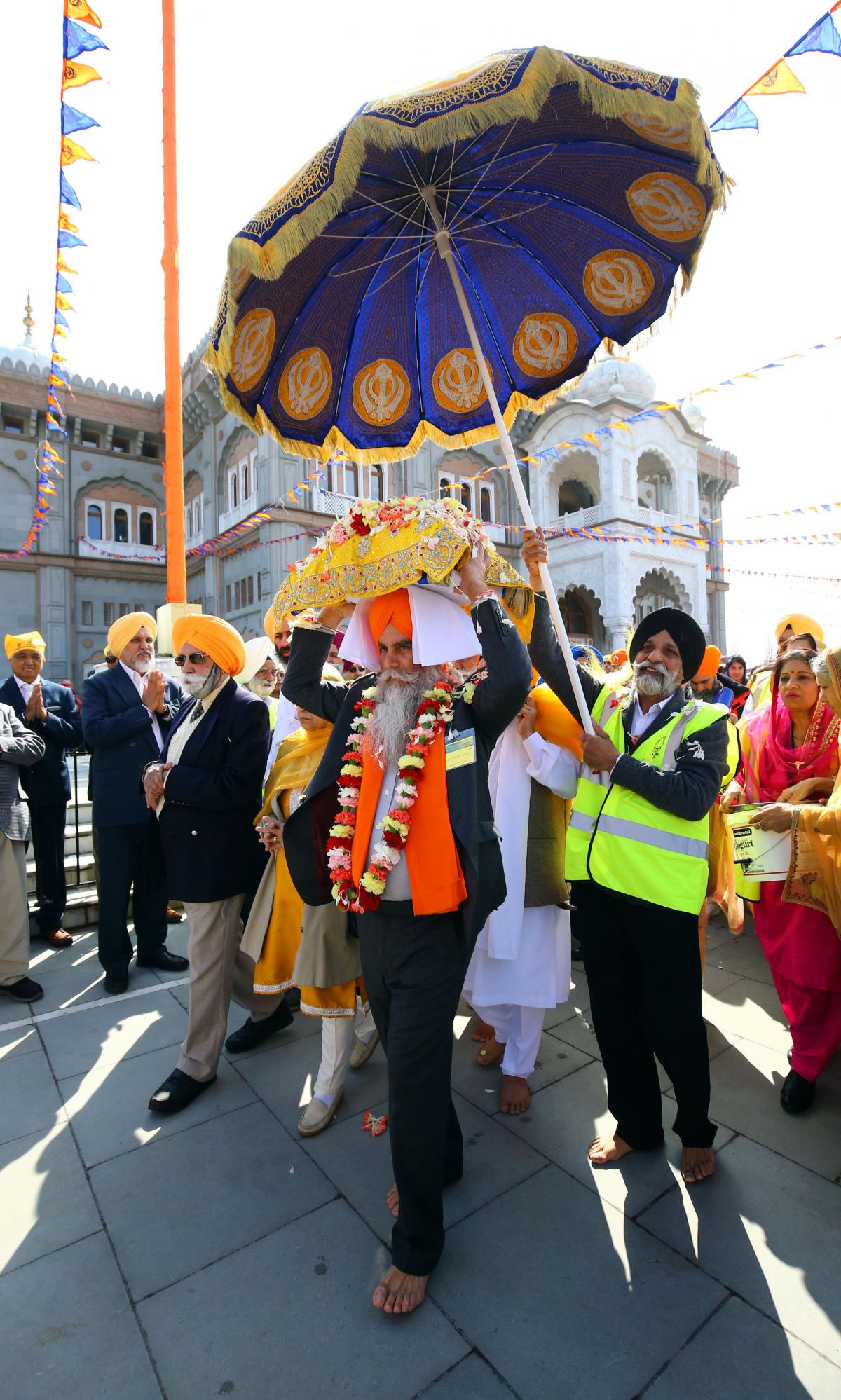 Members of the Sikh community follow the Guru Granth Sahib, the Sikh holy book, during the Nagar Kirtan procession through Gravesend, Kent. (Gareth Fuller/PA)
