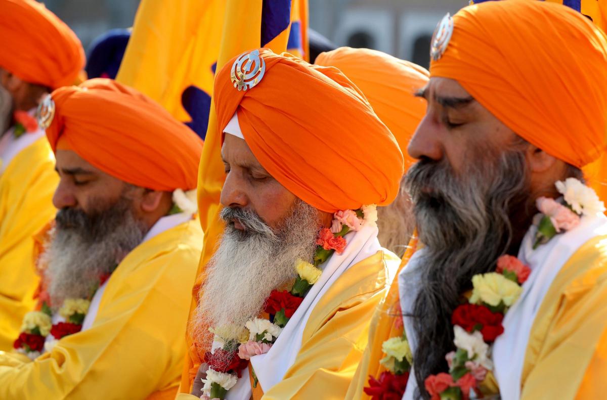 Members of the Sikh community follow the Guru Granth Sahib, the Sikh holy book, during the Nagar Kirtan procession through Gravesend, Kent. (Gareth Fuller/PA)