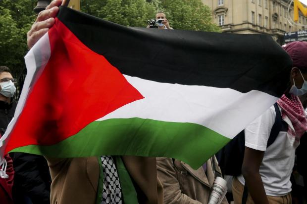 A protester waves a flag during a protest in solidarity with Palestinians, in Paris, Wednesday, May 12, 2021. (AP /Thibault Camus).