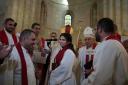 Sally Azar, centre, is applauded by clergy after being ordained in the Old City of Jerusalem