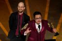 Daniel Scheinert, left, and Daniel Kwan accept the Oscar for best director for Everything Everywhere All at Once