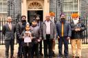 Martin Docherty-Hughes MP alongside Gurpreet Singh Johal and campaigners outside 10 Downing Street in November last year