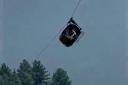 The cable car carrying dangling hundreds of feet above the ground (AP Photo)