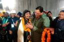 Pushkar Singh Dhami, right, chief minister of the state of Uttarakhand, greeting a worker rescued from the site of an under-construction road tunnel that collapsed in Silkyara in the northern Indian state of Uttarakhand, India (Uttarakhand State