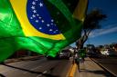 A street vendor sells representations of Brazil's national flags near the Arena Castelao in Fortaleza, Brazil, Wednesday, June 11, 2014. The Brazil 2014 Word Cup soccer tournament is set to begins today. (AP Photo/Fernando Llano)