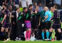 Bayern Munich players argue with referee Szymon Marciniak (Manu Fernandez/AP)