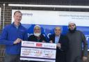 Dan Hill, chief officer of Rosemere Cancer Foundation, far left, receives a cheque for the bladder scanner from Ibrahim Vali Bux, Abdul Aziz Patel and Habibullah Munshi