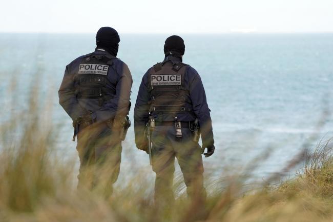 French police officers patrol the beaches in Wimereux near Calais