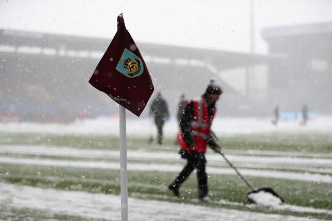 Burnley's home Premier League game was postponed despite attempts to clear the snow at Turf Moor