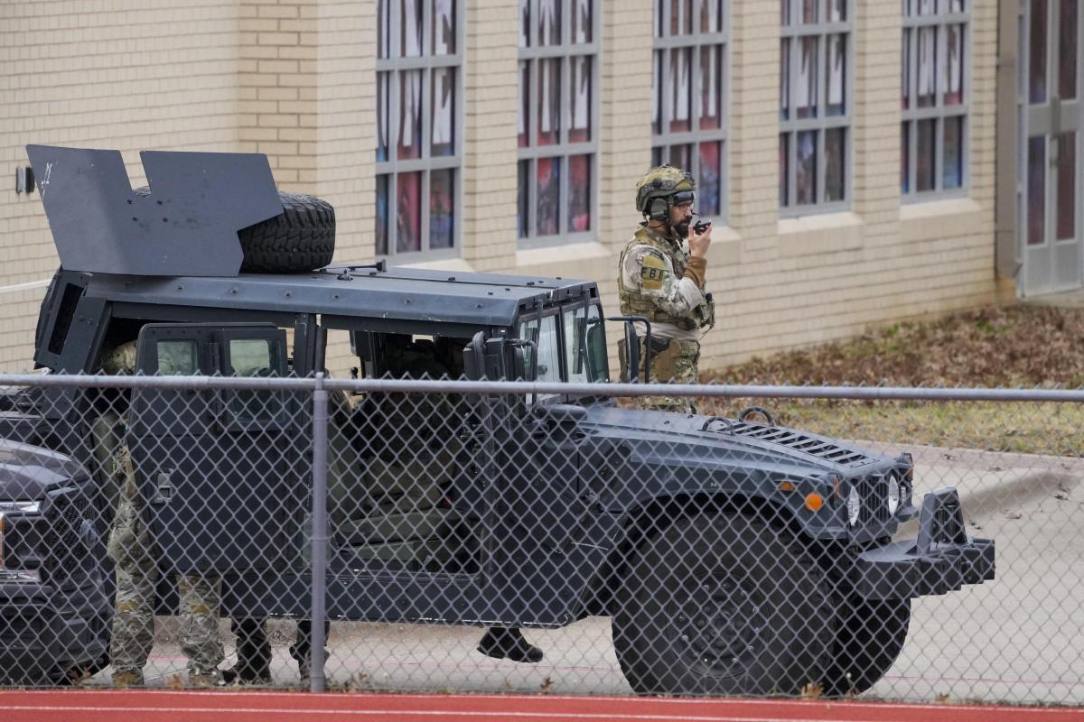 Law enforcement teams stage near Congregation Beth Israel while conducting SWAT operations in Colleyville, Texas on Saturday afternoon, Jan. 15, 2022. (Smiley N. Pool/The Dallas Morning News via AP).