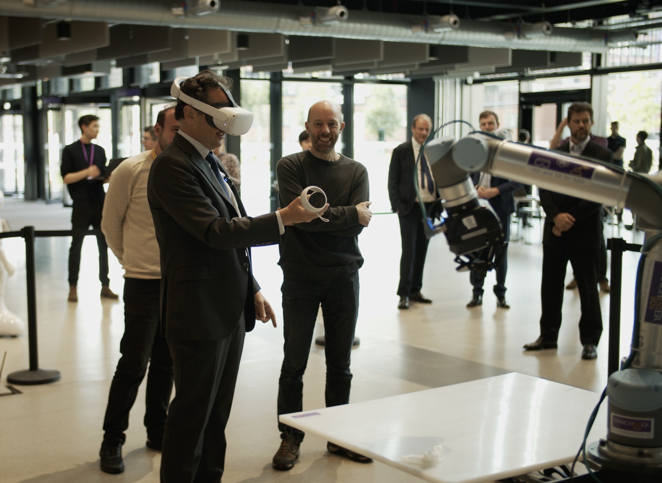 Viscount Camrose, Minister for AI and Intellectual Property uses a VR headset which controls a robot arm at Manchester University Engineering Building (Picture: DSIT)
