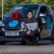 University of Bradford final year law student Shaikhul Amin with new smart car, which he won after taking part in a mock trial competition- Picture- University of Bradford