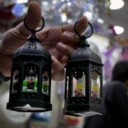 A man displays traditional lanterns for the Muslim holy month of Ramadan at a shop in Beirut, Lebanon, Saturday, April 2, 2022. AP Photo/Bilal Hussein)