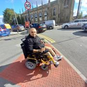 Anish Chudasama near the crossing where he says he was an inch from being hit by a car.