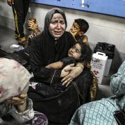 Wounded Palestinians lay at the al-Shifa hospital, following Israeli airstrikes, in Gaza City, central Gaza Strip, Tuesday, Oct. 17, 2023.
