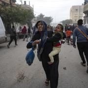 Palestinians evacuate from a site hit by an Israeli bombardment on Rafah, southern Gaza Strip, Wednesday, Dec. 20, 2023.