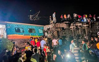 Two passenger trains derailed on Friday in India, killing more than 200 people and trapping hundreds of others inside more than a dozen damaged rail cars, officials said (Press Trust of India/AP)