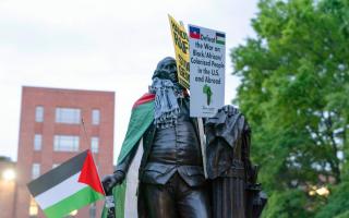 A statue of George Washington is seen with a Palestinian flag during a rally at George Washington University during a pro-Palestinian protest over the Israel-Hamas war (Jose Luis Magana/AP)