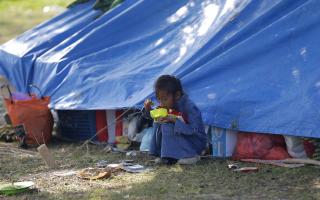 A child eats breakfast at a temporary shelter in Palu
