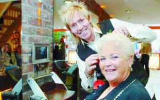 Pam St Clement gets a haircut from Eric Brotherton, owner of Triangles Hair Salon. Picture: COLIN HORNE